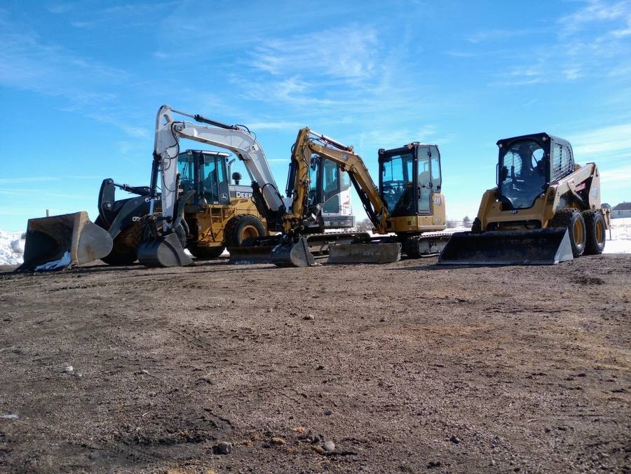 Excavators and skid steer staged for a dig